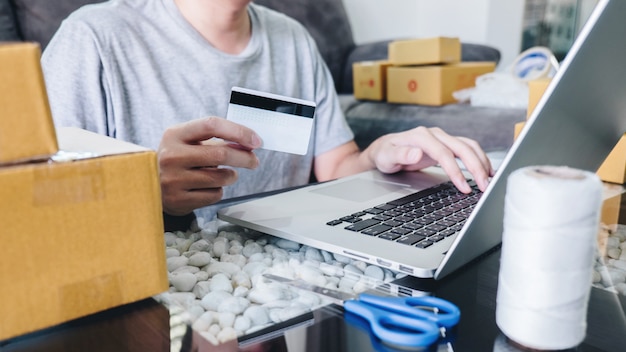 Jovem recebeu compras on-line parcel abrindo caixas e comprando itens por cartão de crédito