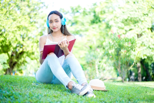 Jovem relaxante no parque natural. Férias no verão no jardim.