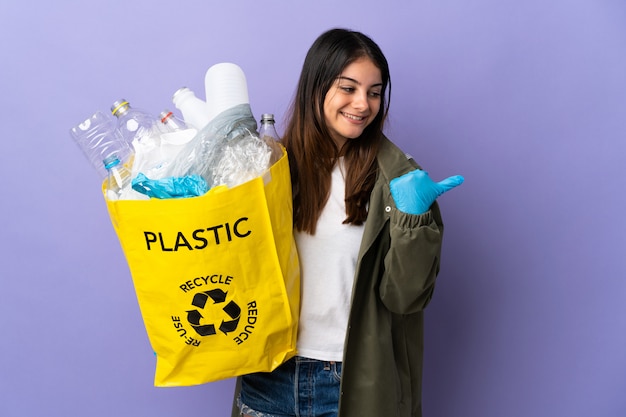 Jovem segurando uma sacola cheia de garrafas plásticas para reciclar