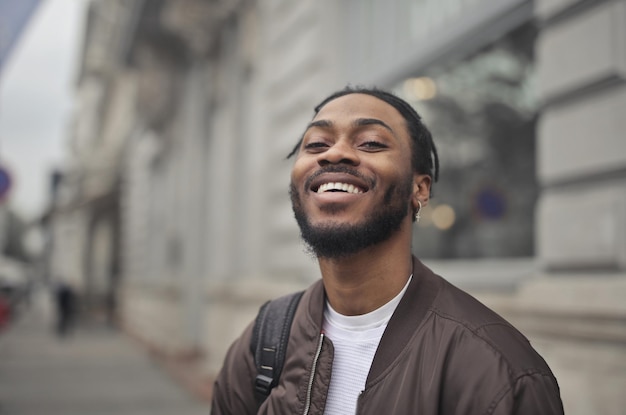 jovem sorridente com mochila na rua