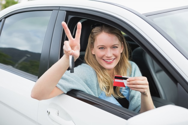 Jovem sorridente e segurando o cartão