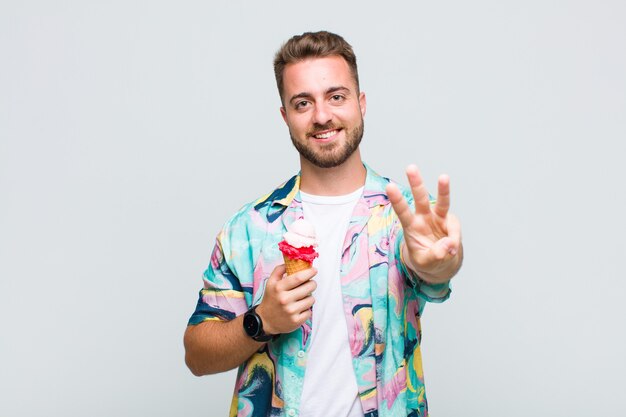 Jovem sorrindo e parecendo amigável, mostrando o número um ou o primeiro com a mão para a frente, em contagem regressiva