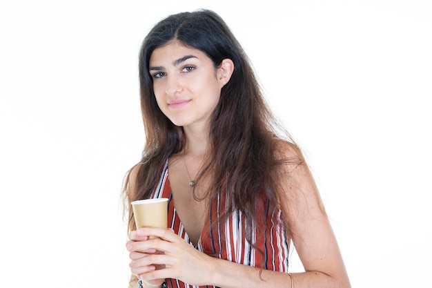 Jovem sorrindo segurando uma xícara quente de café marrom em fundo branco isolado