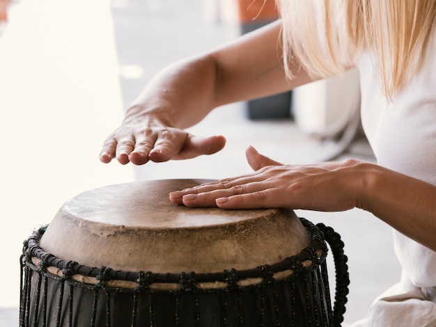 Foto jovem tocando tambor latino