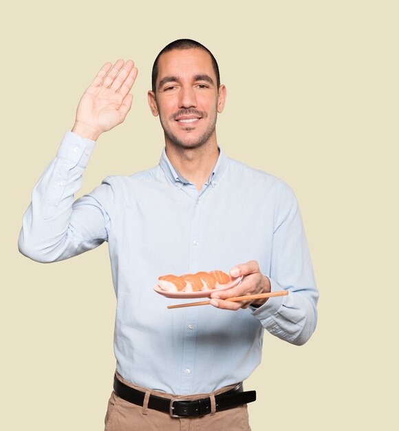 Jovem usando pauzinhos para comer sushi