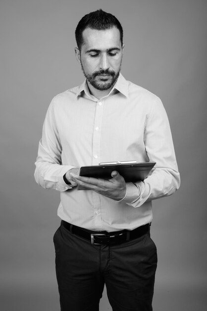 Foto jovem usando smartphone contra um fundo cinzento