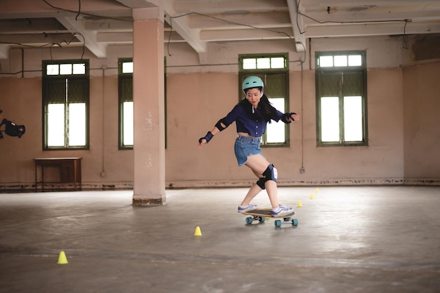 Joven adolescente asiática jugando patineta deporte urbano estilo de vida feliz y divertido con patineta