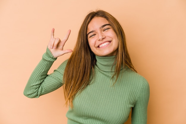 Joven adolescente caucásica flaca mostrando un gesto de cuernos como un concepto de revolución.