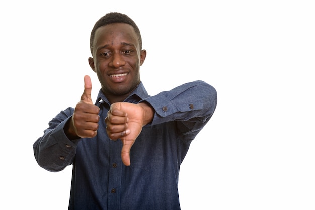 Joven africano feliz sonriendo mientras da los pulgares hacia arriba y hacia abajo