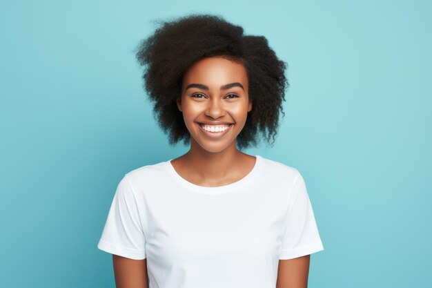 Una joven afroamericana sonriendo y con una camiseta blanca sobre un fondo turquesa