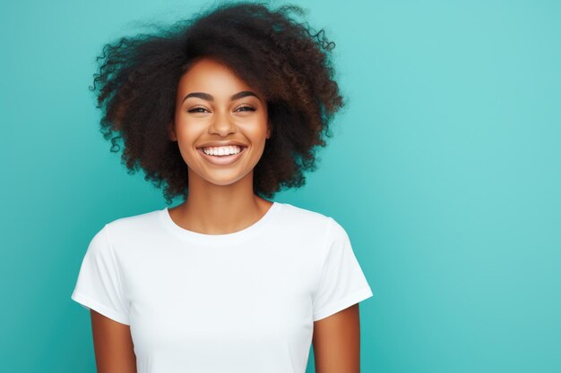 Una joven afroamericana sonriendo y con una camiseta blanca sobre un fondo turquesa