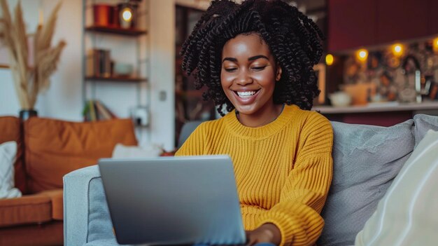 joven afroamericana usando una computadora portátil en casa
