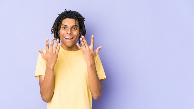 Joven afroamericano rasta mostrando el número diez con las manos.