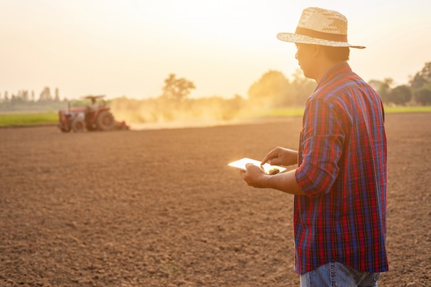 Joven agricultor asiático trabajando en el campo