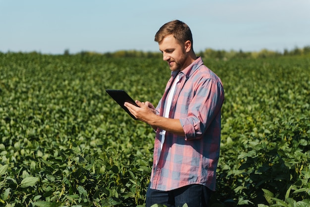 Joven agricultor en campos de soja