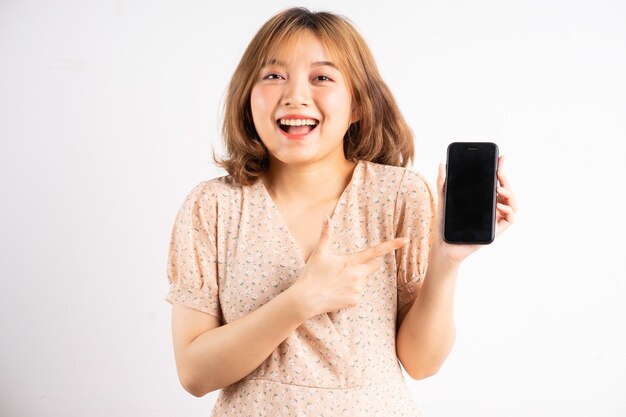 Joven asiática sosteniendo el teléfono con expresiones y gestos en blanco