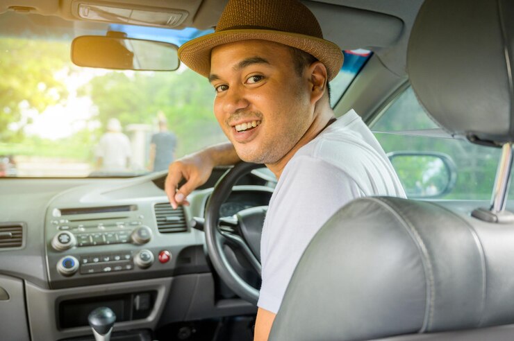 Joven asiático sonriendo en su automóvil Concepto de viaje Primero el concepto de seguro de seguridad