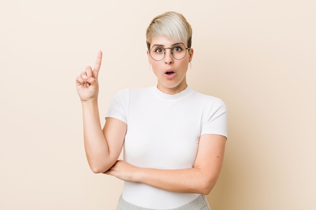 Joven auténtica mujer natural con una camisa blanca con una gran idea, concepto de creatividad.