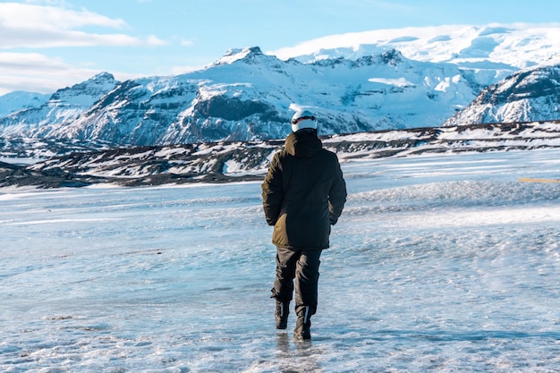 Un joven aventurero caminando por el glaciar Vatnajokull en invierno en Islandia