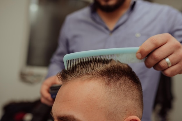 Joven en barbería Concepto de servicio de cuidado del cabello Enfoque selectivo Foto de alta calidad