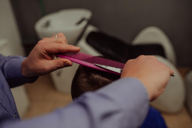 Joven en barbería Concepto de servicio de cuidado del cabello Enfoque selectivo Foto de alta calidad