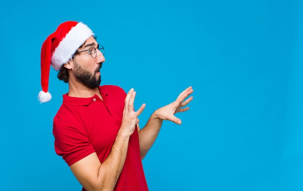 Joven barbudo loco con sombrero de santa. Concepto de navidad