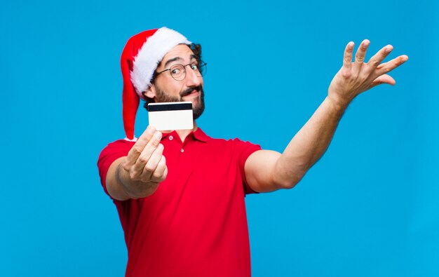 Foto joven barbudo loco con sombrero de santa. concepto de navidad