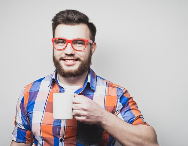 Joven barbudo con una taza de café