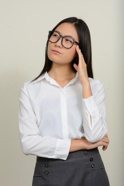 joven y bella empresaria asiática en blanco