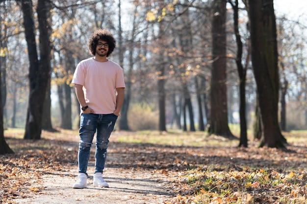 Joven caminando en el bosque de otoño