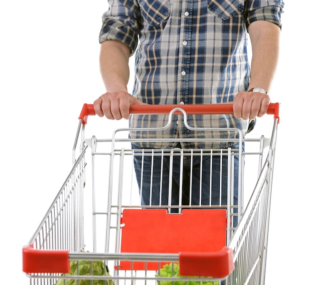Joven con carrito de compras aislado en blanco