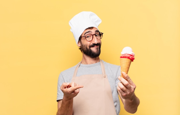 Joven chef barbudo feliz expresión y sosteniendo un helado