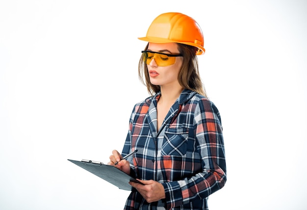 Joven constructora en gafas y casco Atractiva mujer trabajadora en casco