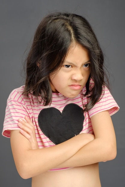 Foto una joven con un corazón en el pecho está de pie con un corazón negro en el pecho.