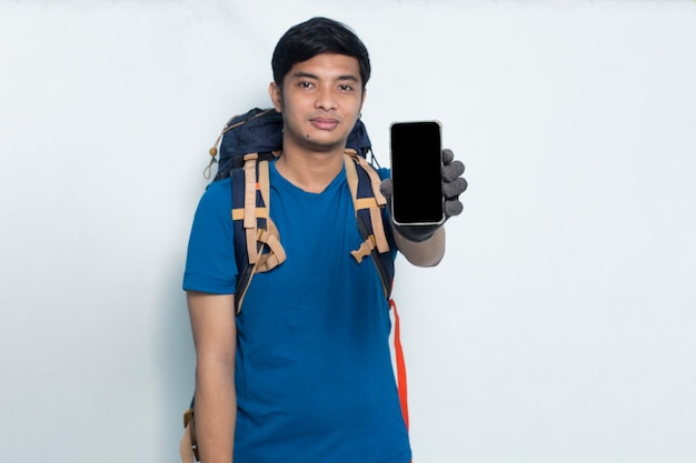 Joven deportista asiático demostrando teléfono móvil sobre fondo blanco.
