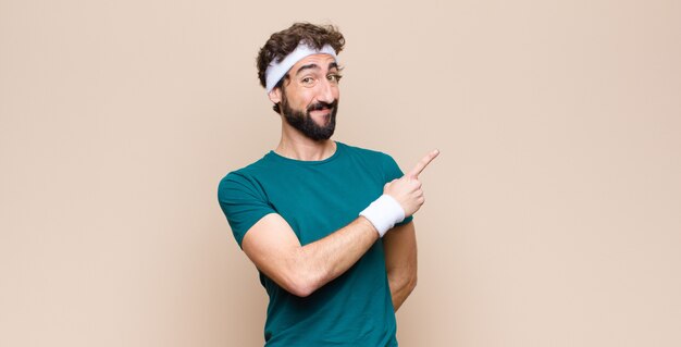 Foto joven deportista expresando un concepto contra la pared plana