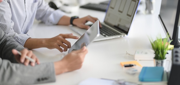 Joven desarrollador web profesional de IU trabajando en su proyecto con computadora portátil y tableta