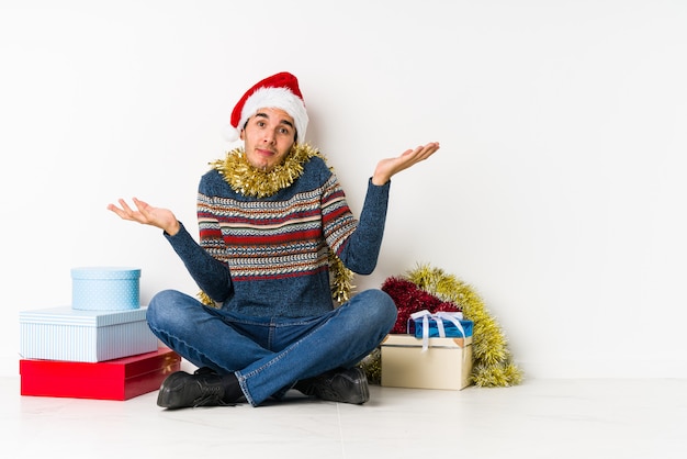 Joven el día de Navidad olvidando algo, golpeándose la frente con la palma y cerrando los ojos.