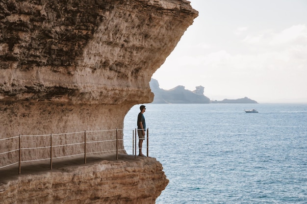 Joven disfrutando de la vista del mar en los acantilados de Bonifacio Córcega