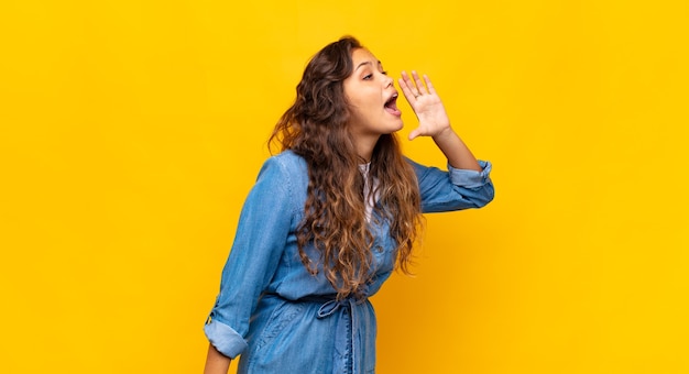 joven y elegante mujer bonita sobre fondo amarillo