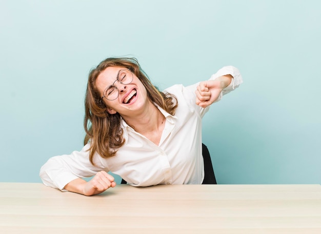 Joven empresaria bonita sentada con una mesa