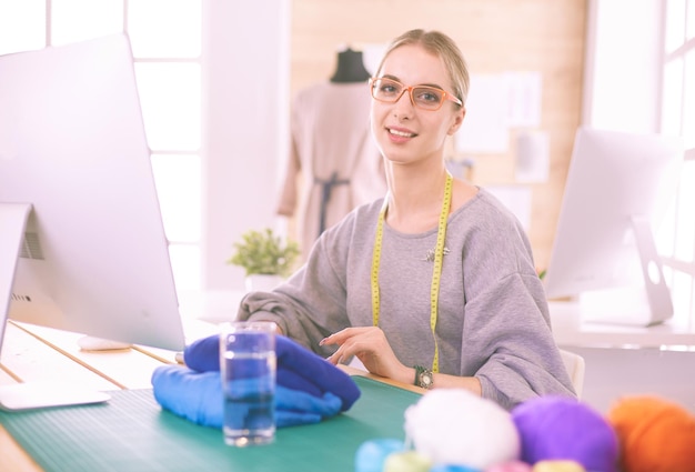 Joven empresaria y diseñadora de moda trabajando en su taller