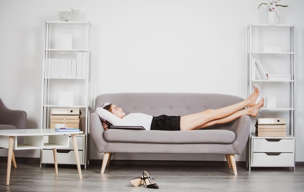 Joven empresaria durmiendo en el lugar de trabajo en la oficina secretaria mujer dormir en ropa formal