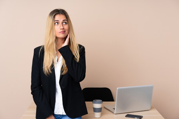 Joven empresaria en una oficina pensando en una idea