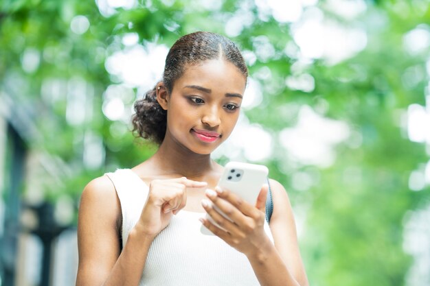 Joven empresaria operando el teléfono inteligente