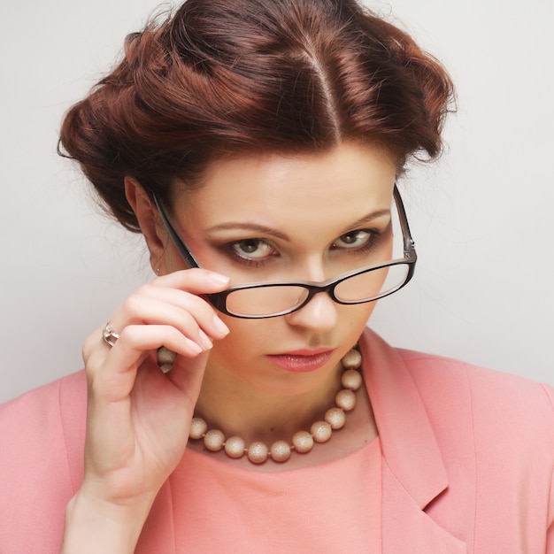 Joven empresaria en rosa con gafas.