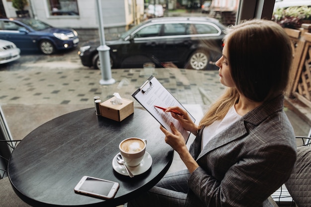 Joven empresaria trabajando en un café