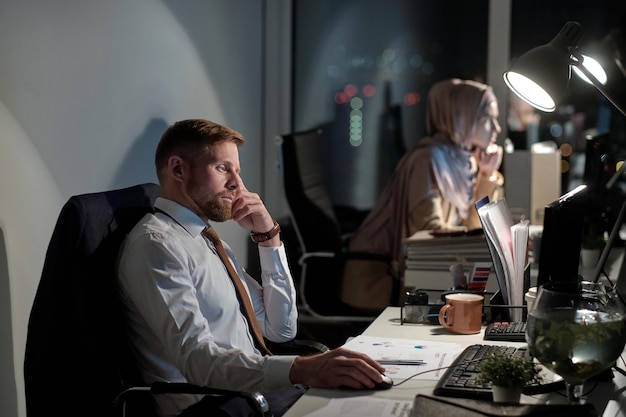 Joven empresario barbudo concentrándose en el trabajo