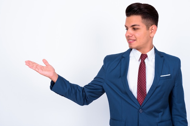 Joven empresario guapo vistiendo traje azul sobre blanco