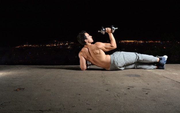 Joven entrenando con mancuernas